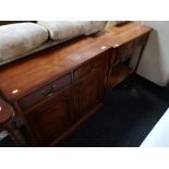 An inlaid yew wood double door cabinet fitted with two drawers together with a two tier hall table