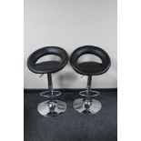 A pair of contemporary gas lift bar stools