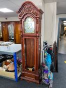 A reproduction grandfather clock with pendulum and weights (front door lacking glass pane)