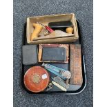 A tray of Chapman woodworking plane, vintage leather tape measure, pocket knives,