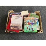 A box of books, children's annuals, paperback novels,