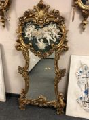 An ornate gilt cherub mirror