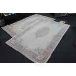 Three floral oriental rugs on cream ground