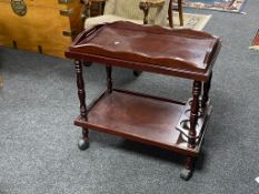 A mahogany effect two tier trolley with lift off tray