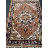A Persian woolen carpet on orange ground