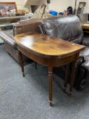 A reproduction mahogany D-shaped turn over topped tea table on tapered legs