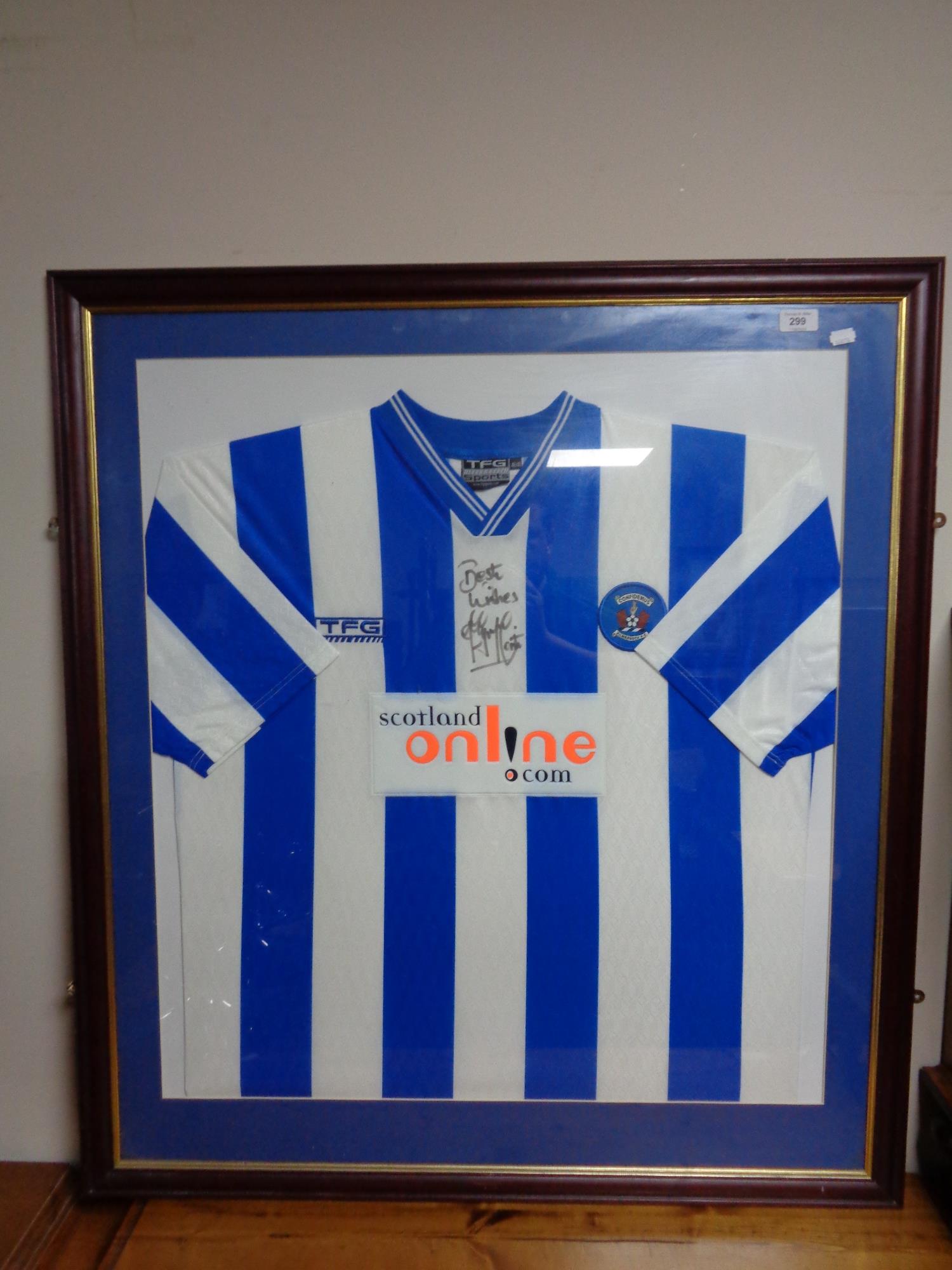 A framed Kilmarnock FC football top with signature