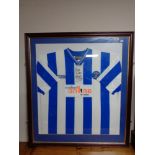 A framed Kilmarnock FC football top with signature