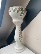 A glazed pottery rose patterned jardiniere on stand