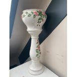 A glazed pottery rose patterned jardiniere on stand