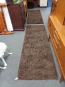 A pair of contemporary brown carpet runners