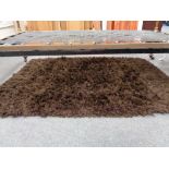 A contemporary brown rug
