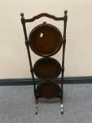 An antique three tier folding cake stand