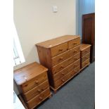 A contemporary pine six drawer chest together with a pair of three drawer bedside chests