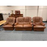 A brown leather three piece lounge suite