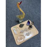 A tray of assorted glass ornaments, wolf and swan paperweights, penguin family,