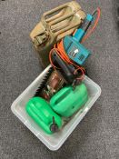 A box of Black and Decker hedge trimmer, two oil cans,