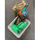 A box of Black and Decker hedge trimmer, two oil cans,