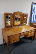 A Jaycee pine kneehole dressing table with triple mirror