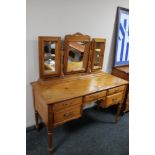 A Jaycee pine kneehole dressing table with triple mirror