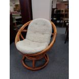 A bamboo and wicker swivel tub chair