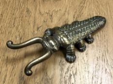 A Victorian brass 'Beatle' boot pull by Edmund Ashworth, Bradford.