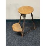 A vintage cast iron and pine sewing stool