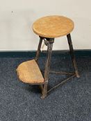 A vintage cast iron and pine sewing stool