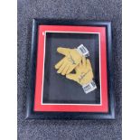 A framed pair of goalkeeper's gloves with signature