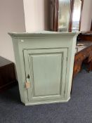 A painted hanging corner cabinet