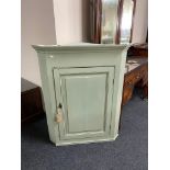 A painted hanging corner cabinet