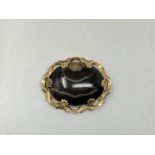 An antique gold and agate brooch