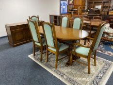 A nine piece Parker knoll dining room suite comprising of three door low sideboard,