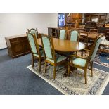 A nine piece Parker knoll dining room suite comprising of three door low sideboard,