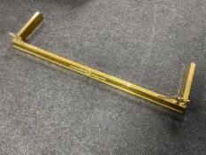 An antique brass fire curb