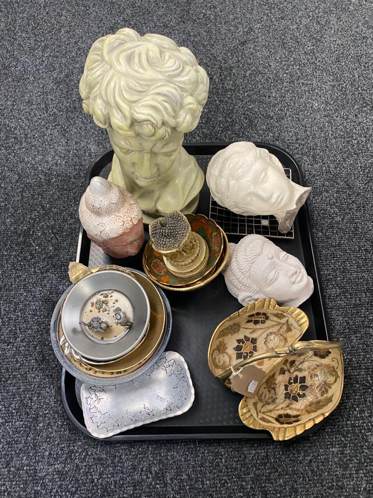 A tray containing busts,