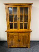 A contemporary hardwood double door bookcase fitted with cupboard beneath