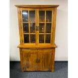 A contemporary hardwood double door bookcase fitted with cupboard beneath