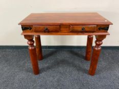 An Eastern hardwood hall table fitted with two drawers