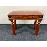 An Eastern hardwood hall table fitted with two drawers