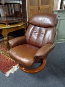 A tan leather Stressless style swivel armchair