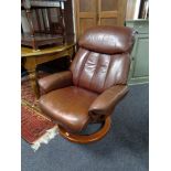 A tan leather Stressless style swivel armchair