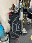 A golf bag containing seven Ping irons together with a Taylor Made driver