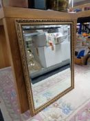 A gilt framed bevelled mirror