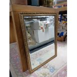 A gilt framed bevelled mirror