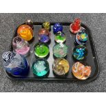 A tray of sixteen assorted glass paperweights