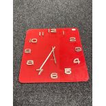 A red glass Karlsson battery operated wall clock