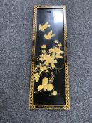 A Chinese black lacquered embossed wall plaque