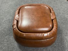A brown leather storage footstool