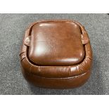 A brown leather storage footstool